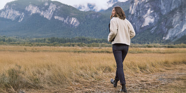Woman wearing Duer Womens Jeans while adventuring a mountain landscape