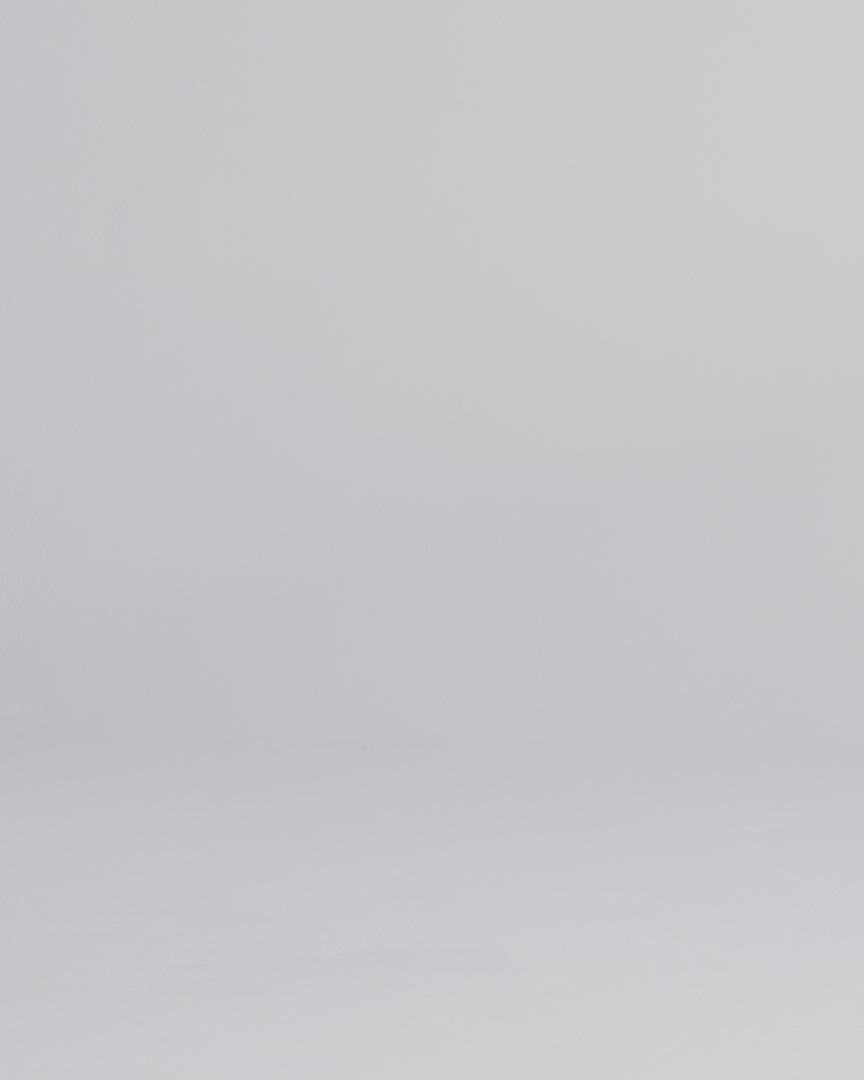 man wearing grey waterproof pants walking into frame, zipping the thigh pocket, adjusting the snap cuff, and stretching the thigh fabric