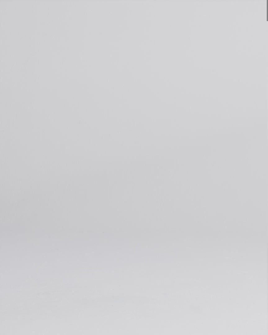 Woman wearing a dark wash relaxed fit stretch jeans walking onto screen, posing, and crouching down to face the camera.