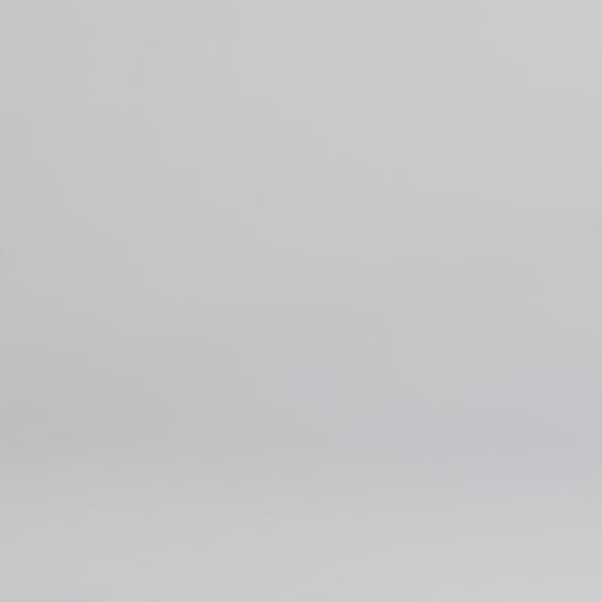 Man wearing dark wash slim fit stretch jeans walking into the frame, posing and adjusting the cuff.