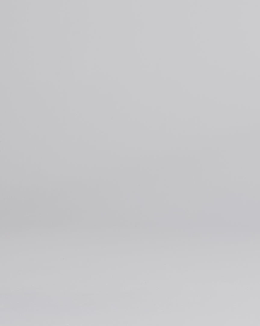 Man wearing dark wash slim fit stretch jeans walking into the frame, posing and adjusting the cuff.