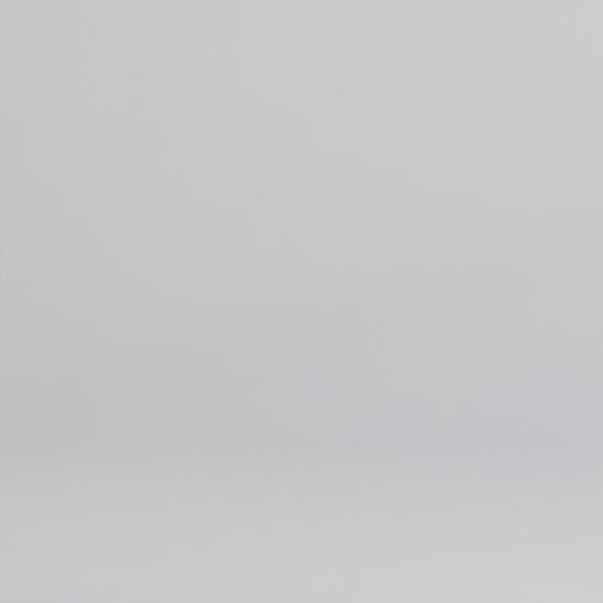 Man wearing dark wash slim fit stretch jeans walking into the frame, posing and adjusting the cuff.